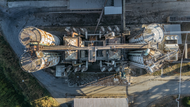 Aerial view of industrial grain silos and processing facility with metal structures pipes and concrete surfaces in Sremska Mitrovica Vojvodina Serbia. Aerial view of industrial grain silos and processing facility with metal structures pipes and concrete surfaces in Sremska Mitrovica Vojvodina Serbia.