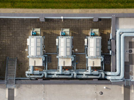 Aerial view of three industrial HVAC units on the rooftop of Factory Annopol with grey ventilation pipes and metal stairs in Warszawa Mazowieckie Poland. Aerial view of three industrial HVAC units on the rooftop of Factory Annopol with grey ventilation pipes and metal stairs in Warszawa Mazowieckie Poland.