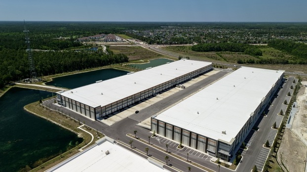 Aerial view of a large modern warehouse complex with white roofs and retention ponds near Saint Johns Parkway and International Golf Parkway in World Golf Village Florida United States. Aerial view of a large modern warehouse complex with white roofs and retention ponds near Saint Johns Parkway and International Golf Parkway in World Golf Village Florida United States.