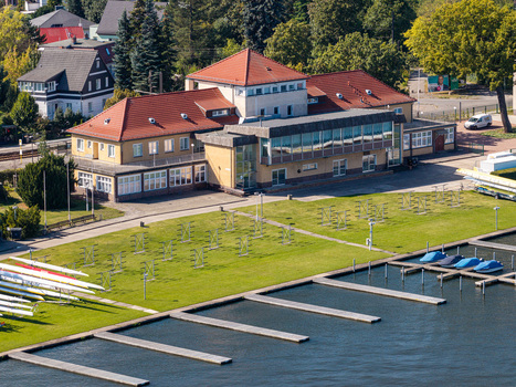 Aerial view of Berlin Grunau Regatta Course with its historic clubhouse rowing boats on the lawn and floating docks on the Dahme river in Berlin Berlin Germany. Aerial view of Berlin Grunau Regatta Course with its historic clubhouse rowing boats on the lawn and floating docks on the Dahme river in Berlin Berlin Germany.