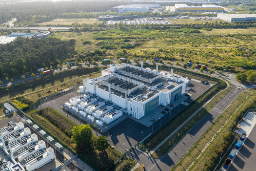Aerial view of Vantage Data Centers BER1 facility with industrial cooling units and surrounding green landscape in Ludwigsfelde Brandenburg Germany. Aerial view of Vantage Data Centers BER1 facility with industrial cooling units and surrounding green landscape in Ludwigsfelde Brandenburg Germany.