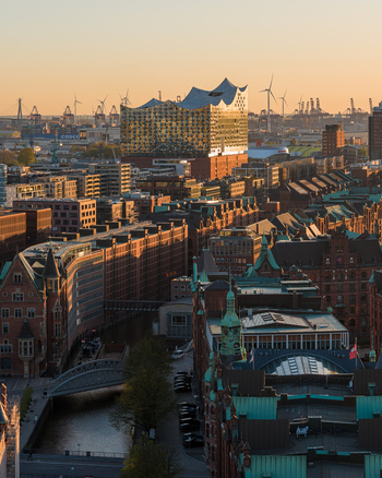 Aerial view of the historic Speicherstadt warehouse district and the modern Elbphilharmonie concert hall at sunset in Hamburg Hamburg Germany. Aerial view of the historic Speicherstadt warehouse district and the modern Elbphilharmonie concert hall at sunset in Hamburg Hamburg Germany.