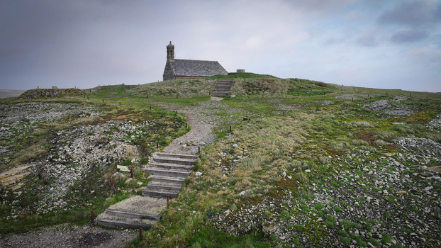 Aerial view of Mont Saint Michel de Brasparts chapel on a rocky hilltop with stone steps under a cloudy sky Saint Rivoal Bretagne France. Aerial view of Mont Saint Michel de Brasparts chapel on a rocky hilltop with stone steps under a cloudy sky Saint Rivoal Bretagne France.
