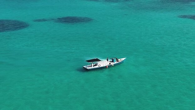 Aerial view of a boat on turquoise water Maldives. Aerial view of a boat on turquoise water Maldives.