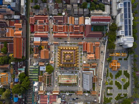 Bangkok Thailand 26 April 2026 Aerial view of the Loha Prasat at Wat Ratchanatdaram temple complex with its golden spires and traditional red tiled rooftops under bright sunlight.