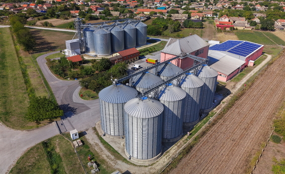 Aerial view of storage silo Bavaniste featuring metallic grain bins and industrial buildings with solar panels Bavaniste Vojvodina Serbia.