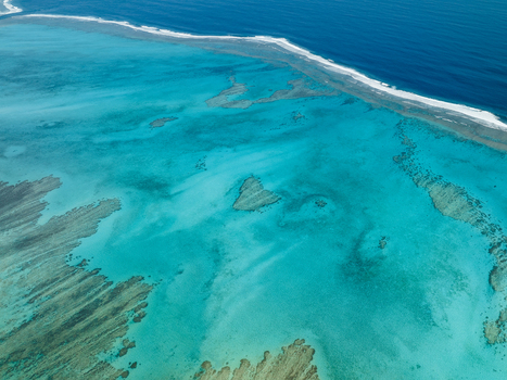Aerial view of the vibrant turquoise ocean meeting the coral reefs a mesmerizing dance of color and texture Noumea South Province New Caledonia.