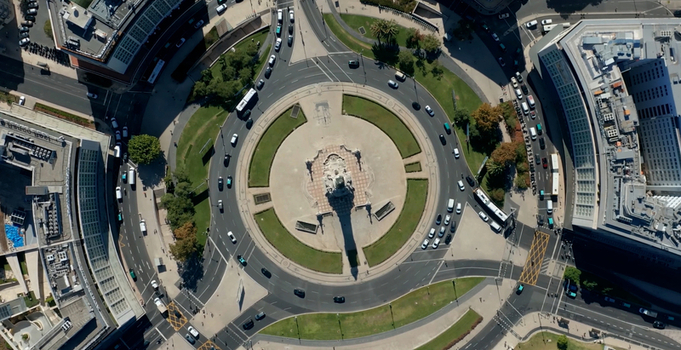 Aerial view of Marquis of Pombal Square featuring a central monument circular traffic flow surrounding urban buildings and manicured green spaces in Lisboa Lisboa Portugal. Aerial view of Marquis of Pombal Square featuring a central monument circular traffic flow surrounding urban buildings and manicured green spaces in Lisboa Lisboa Portugal.