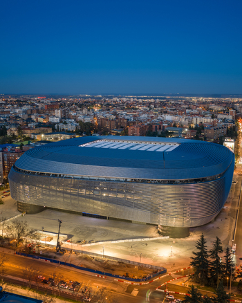 Aerial view of Santiago Bernabeu stadium featuring its modern metallic facade and surrounding urban landscape in Madrid Community of Madrid Spain. Aerial view of Santiago Bernabeu stadium featuring its modern metallic facade and surrounding urban landscape in Madrid Community of Madrid Spain.