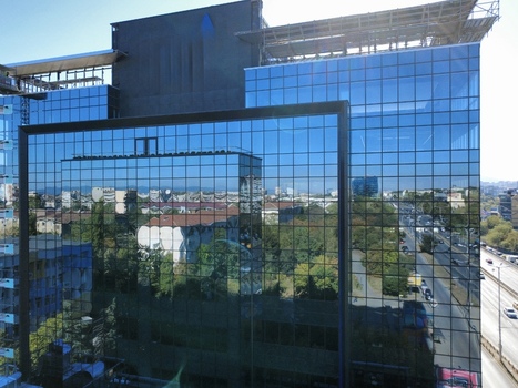 Aerial view of modern glass office building with city reflections on the facade urban landscape Sofia Sofia City Province Bulgaria. Aerial view of modern glass office building with city reflections on the facade urban landscape Sofia Sofia City Province Bulgaria.