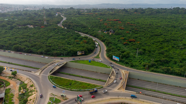 Accra Ghana 02 June 2023 Aerial view of Forever roundabout featuring a multi level interchange with surrounding lush green vegetation and traffic flowing on the highway.