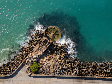 Aerial view of the Rio Ozama breakwater with concrete tetrapods protecting the coastline against the turquoise Caribbean Sea in Santo Domingo Santo Domingo Dominican Republic.