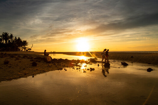 Cebu Philippines 21 June 2026 View of Bantayan Island at sunset with people walking along the shallow shoreline and palm trees silhouetted against the golden sky. Cebu Philippines 21 June 2026 View of Bantayan Island at sunset with people walking along the shallow shoreline and palm trees silhouetted against the golden sky.