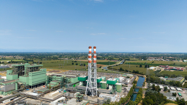 Aerial view of the TTEP Tavazzano thermal power plant and TERNA electrical substation with tall chimneys and industrial buildings in Tavazzano con Villavesco Lombardy Italy.