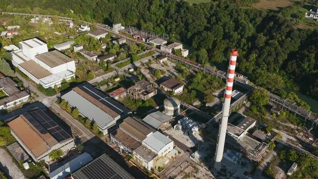 Aerial view of industrial site with tall chimney Italy. Aerial view of industrial site with tall chimney Italy.