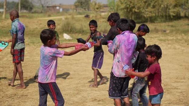 View of children playing with colored water during a festival Nepal.