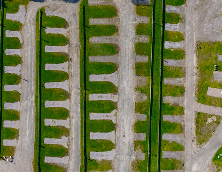 Aerial view of the parking area with gravel spaces separated by green grass strips in Geiranger More og Romsdal Norway. Aerial view of the parking area with gravel spaces separated by green grass strips in Geiranger More og Romsdal Norway.