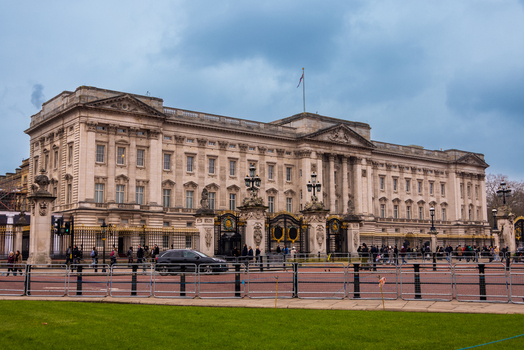 London United Kingdom 12 May 2025 View of Buckingham Palace with its iconic neoclassical facade and ornate gates under a cloudy sky.