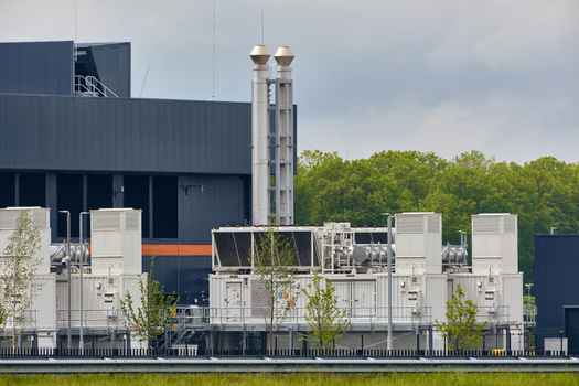 Middenmeer Netherlands 17 May 2026 View of the Microsoft datacenters on Agriport featuring industrial cooling units and exhaust stacks against a cloudy sky.