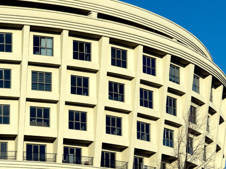 View of modern curved building facade with numerous windows and balconies under a clear blue sky Istanbul Istanbul Turkiye. View of modern curved building facade with numerous windows and balconies under a clear blue sky Istanbul Istanbul Turkiye.