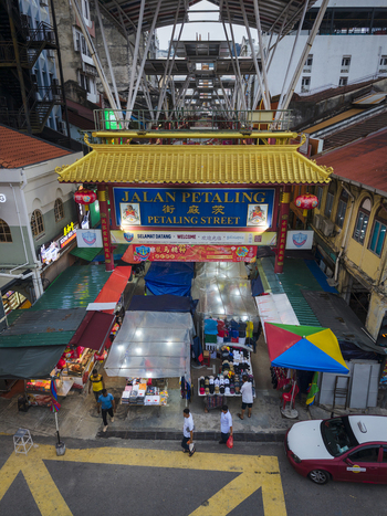 Kuala Lumpur Malaysia 09 March 2026 Aerial view of the iconic Petaling Street entrance gate in Chinatown with its traditional yellow roof and bustling market stalls.