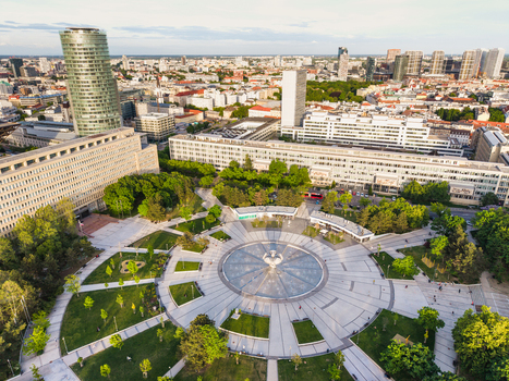 Aerial view of Freedom Square featuring the circular Druzba Fountain surrounded by lush green trees and modern urban architecture in Bratislava I Bratislavsky kraj Slovakia. Aerial view of Freedom Square featuring the circular Druzba Fountain surrounded by lush green trees and modern urban architecture in Bratislava I Bratislavsky kraj Slovakia.