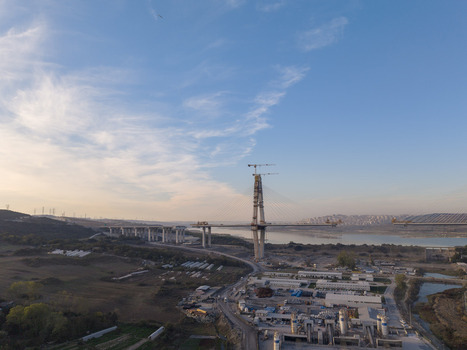 Aerial view of the Yavuz Sultan Selim Bridge under construction featuring a tall concrete pylon steel cables and surrounding landscape near the Bosphorus in Istanbul Istanbul Turkiye.