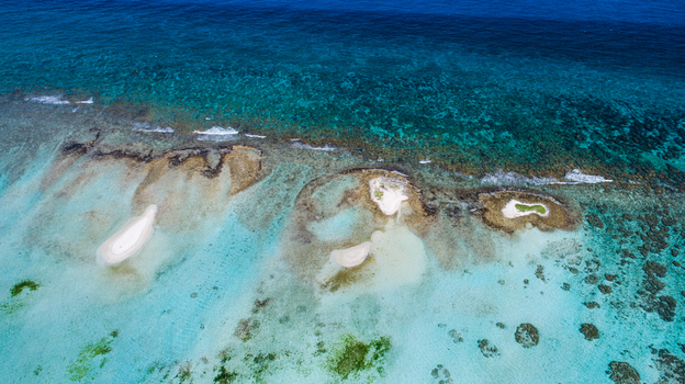 Aerial view of Los Roques archipelago featuring small white sand cays surrounded by turquoise coral reefs and clear Caribbean waters Los Roques Dependencias Federales Venezuela. Aerial view of Los Roques archipelago featuring small white sand cays surrounded by turquoise coral reefs and clear Caribbean waters Los Roques Dependencias Federales Venezuela.