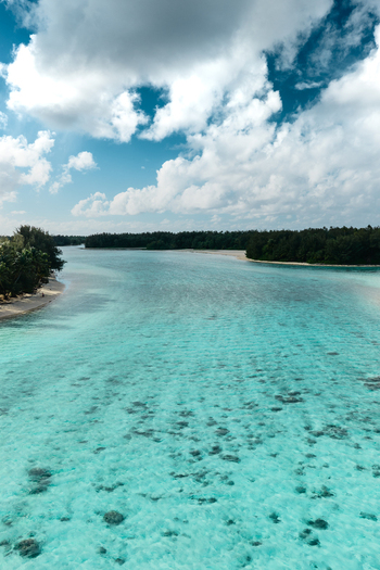 Aerial view of the turquoise lagoon and coral reefs surrounding the tropical island of Rarotonga Cook Islands. Aerial view of the turquoise lagoon and coral reefs surrounding the tropical island of Rarotonga Cook Islands.