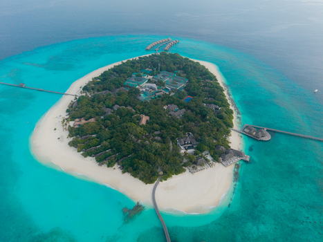 Aerial view of a vibrant green island fringed by brilliant white sands and stunning turquoise waters Hoarafushi Thiladhunmathee Uthuruburi Maldives. Aerial view of a vibrant green island fringed by brilliant white sands and stunning turquoise waters Hoarafushi Thiladhunmathee Uthuruburi Maldives.