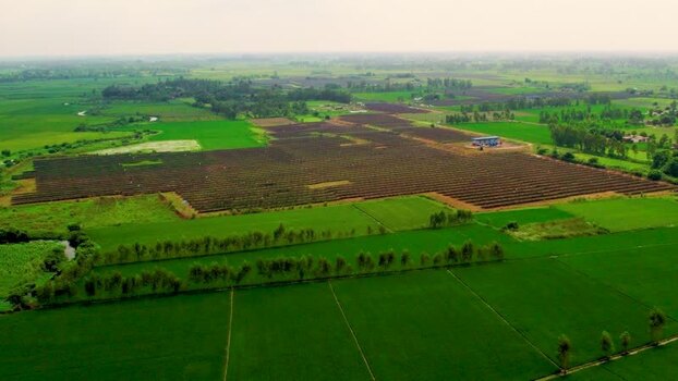 Aerial view of solar farm in rural landscape India.