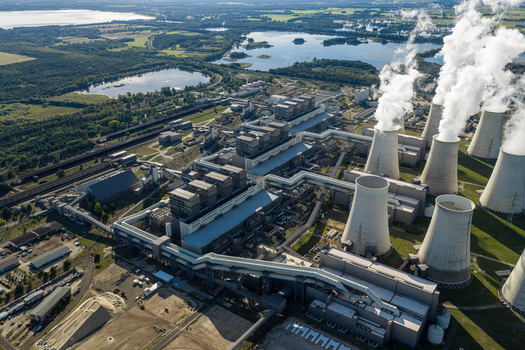 Aerial view of Janschwalde Power Station with large cooling towers emitting steam industrial infrastructure and surrounding lakes in Peitz Brandenburg Germany. Aerial view of Janschwalde Power Station with large cooling towers emitting steam industrial infrastructure and surrounding lakes in Peitz Brandenburg Germany.