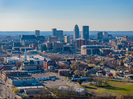 Aerial view of the Louisville skyline featuring modern skyscrapers historic brick buildings and urban streets under a clear blue sky in Louisville Kentucky United States. Aerial view of the Louisville skyline featuring modern skyscrapers historic brick buildings and urban streets under a clear blue sky in Louisville Kentucky United States.