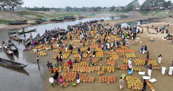 Aerial view of a busy riverside fruit market in Sylhet Bangladesh.