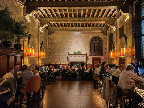 New York United States 14 May 2026 View of the Campbell Apartment bar inside Grand Central Terminal with people dining under an ornate coffered ceiling and a large fireplace.