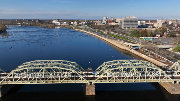Aerial view of the Trenton Makes The World Takes bridge spanning the Delaware River with the city skyline in the background in Trenton New Jersey United States.