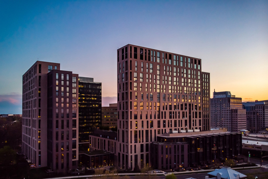 Reston Virginia United States 12 April 2020 Aerial view of modern high rise buildings with glass facades and geometric architecture during the golden hour.