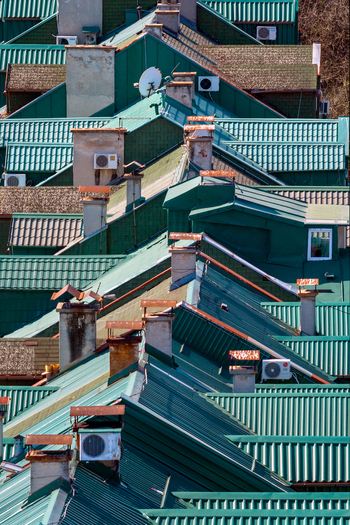 Aerial view of green metal rooftops with chimneys and air conditioning units in Belgrade City of Belgrade Serbia. Aerial view of green metal rooftops with chimneys and air conditioning units in Belgrade City of Belgrade Serbia.