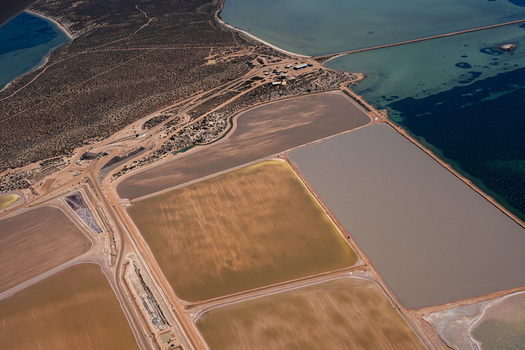 Aerial view of Useless Loop salt mines showing industrial patterns and sediment rich water after a storm in Kalbarri Western Australia Australia. Aerial view of Useless Loop salt mines showing industrial patterns and sediment rich water after a storm in Kalbarri Western Australia Australia.