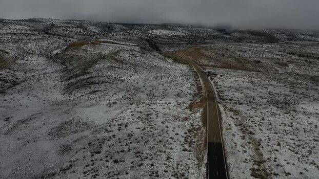 Aerial view of road through snowy hills United States. Aerial view of road through snowy hills United States.