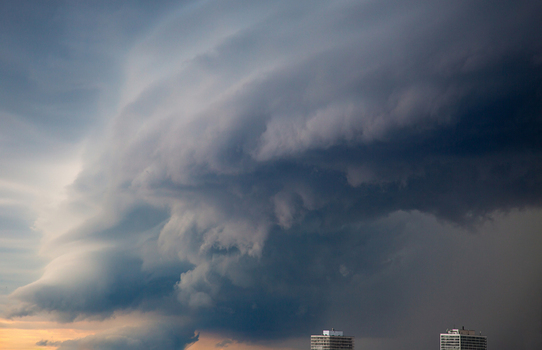Aerial view of dramatic storm clouds and a shelf cloud formation over the city skyline and residential buildings in Toronto Ontario Canada.