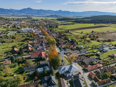 Aerial view of the charming village nestled among rolling hills with its church steeple piercing the skyline and colorful trees lining the streets Klastor pod Znievom Zilina Region Slovakia. Aerial view of the charming village nestled among rolling hills with its church steeple piercing the skyline and colorful trees lining the streets Klastor pod Znievom Zilina Region Slovakia.