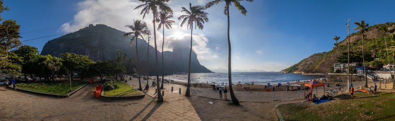 Rio de Janeiro Brazil 06 June 2026 Aerial view of Red Beach with Sugarloaf Mountain tall palm trees and people relaxing on the sand under a bright sky. Rio de Janeiro Brazil 06 June 2026 Aerial view of Red Beach with Sugarloaf Mountain tall palm trees and people relaxing on the sand under a bright sky.
