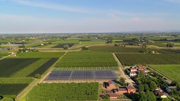 Aerial view of solar panels in agricultural fields Italy.