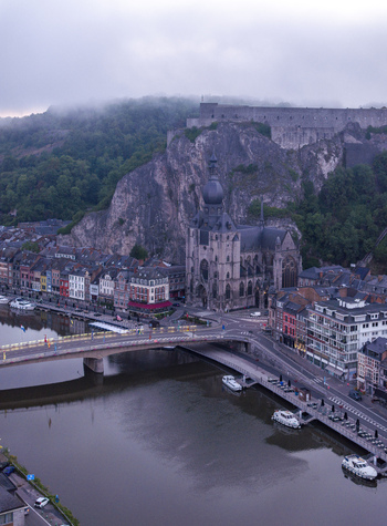 Aerial view of the Collegiate Church of Our Lady of Dinant and the citadel on the cliff overlooking the Meuse river in Dinant Wallonia Belgium. Aerial view of the Collegiate Church of Our Lady of Dinant and the citadel on the cliff overlooking the Meuse river in Dinant Wallonia Belgium.