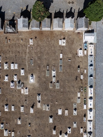 Aerial view of the historic cemetery in Evora featuring rows of stone graves pathways and trees in Evora Evora District Portugal. Aerial view of the historic cemetery in Evora featuring rows of stone graves pathways and trees in Evora Evora District Portugal.
