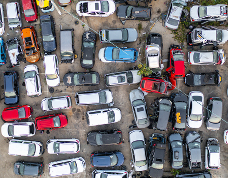 Aerial view of a car junk yard with many damaged and abandoned vehicles parked in rows on a paved lot in Petah Tikva Center District Israel. Aerial view of a car junk yard with many damaged and abandoned vehicles parked in rows on a paved lot in Petah Tikva Center District Israel.