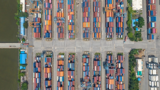 Aerial view of Jawaharlal Nehru Port Authority showing rows of colorful shipping containers gantry cranes and port infrastructure in Juna Sheva Maharashtra India. Aerial view of Jawaharlal Nehru Port Authority showing rows of colorful shipping containers gantry cranes and port infrastructure in Juna Sheva Maharashtra India.