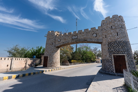 View of the historic stone archway of the Khyber Pass gate under a clear blue sky in Khyber District Khyber Pakhtunkhwa Pakistan.