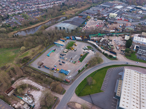 Aerial view of a sprawling industrial landscape with metal buildings and parked vehicles next to a river Dudley United Kingdom. Aerial view of a sprawling industrial landscape with metal buildings and parked vehicles next to a river Dudley United Kingdom.